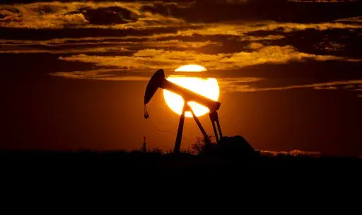 The sun sets behind an idle pump jack near Karnes City, USA, April 8, 2020. Oil prices are sagging amid fears of recessions across the globe. OPEC and allied countries are weighing what to do about that when they meet online Thursday, Sept. 8, 2022. High oil prices were a bonanza for countries like Saudi Arabia over the summer, but now they're well off those highs. Saudi Arabia's oil minister has even said the group known as OPEC+ could cut production at any time. (AP Photo/Eric Gay, File)