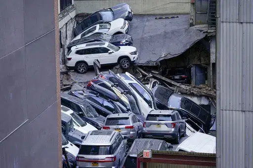 FILE — Cars are seen piled on top of each other at the scene of a partial collapse of a parking garage in the Financial District of New York, April 18, 2023, in New York. After the deadly collapse of a parking structure in lower Manhattan, New York City building officials swept through dozens of parking garages and ordered four of them to immediately shutter because of structural issues that "deteriorated to the point where they were now posing an immediate threat to public safety." (AP Photo/