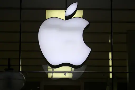The Apple logo is illuminated at a store in the city center of Munich, Germany, Dec. 16, 2020. Apple Inc. is raising the prices for its AppleTV+ streaming and Arcade gaming plans, as well as its bundled Apple One service that includes streaming, music and other subscriptions. (AP Photo/Matthias Schrader, File)