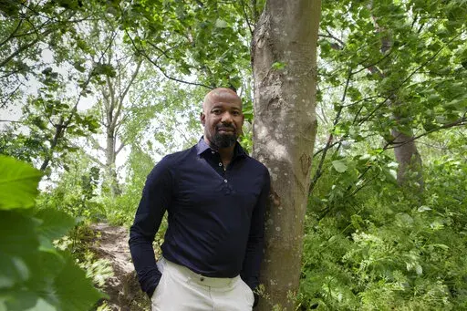 Peris Conrad of the Dutch police poses for a picture in Rotterdam, Netherlands, Thursday, May 26, 2022. Conrad features in a new documentary about discrimination within the ranks of the Netherlands police which has sparked a national conversation about racism, with many officers and others hoping this will finally bring about the change they have long been fighting for. "De Blauwe Familie", or "The Blue Family", discusses a culture of bullying and fear in the national police force. (AP Photo/Jan