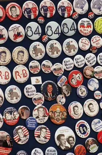 This photo shows buttons from the 1984 Reagan-Bush campaign. Reagan announced on Jan. 29, 1984. His approval rating was 52% that month. Despite concerns about his age — he was 73 and the oldest president in history at the time — Reagan handily defeated Walter Mondale, a Democrat. (AP Photo, File)