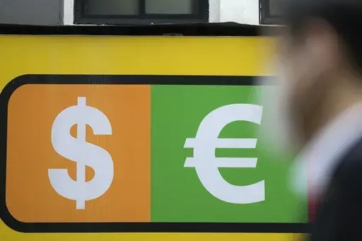 A man walks near a sign of foreign currency outside a money exchange office at a shopping district in Seoul, South Korea, Thursday, April 6, 2023. Asian shares were trading mostly lower Thursday as investors turned their attention to upcoming earnings reports and other economic indicators.(AP Photo/Lee Jin-man)