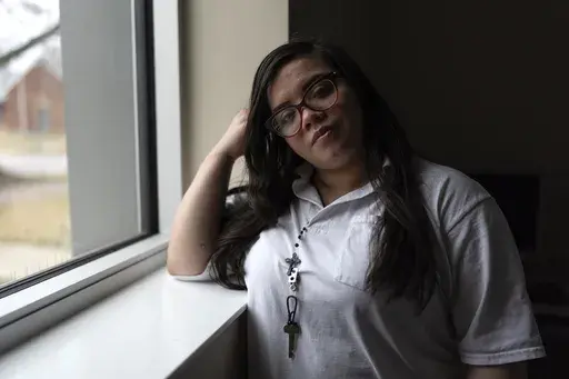 31-year-old Crystal Martinez stands for a portrait after speaking about her experiences with domestic violence and life in prison without her children Friday, Jan. 26, 2024, at Logan Correctional Center in Lincoln, Ill. Martinez's eight-year sentence for shooting a man she said was beating his girlfriend at the time was recently reduced under an Illinois law that allows survivors of domestic violence to ask for shorter sentences. (AP Photo/Erin Hooley)