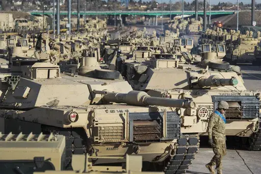 A soldier walks past a line of M1 Abrams tanks, Nov. 29, 2016, at Fort Carson in Colorado Springs, Colo. U.S. officials say the Pentagon is speeding up its delivery of Abrams tanks to Ukraine, opting to send a refurbished older model that can be ready faster. The aim is to get the 70-ton battle powerhouses to the war zone in eight to 10 months. (Christian Murdock/The Gazette via AP, File)