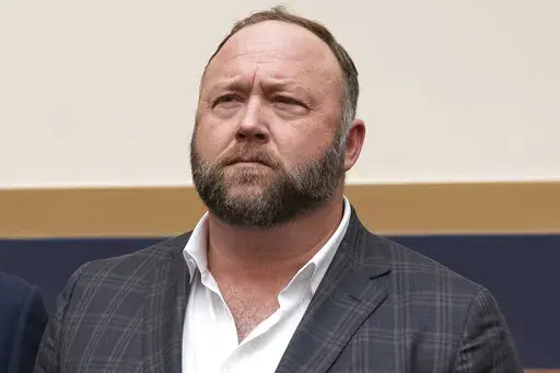 This Tuesday, Dec. 11, 2018, file photo shows radio show host and conspiracy theorist Alex Jones at Capitol Hill in Washington. Infowars host Jones has offered to pay $120,000 per plaintiff to resolve a lawsuit by relatives of Sandy Hook Elementary School shooting victims who said he defamed them by asserting the massacre never happened, according to court filings Tuesday, March 29, 2022. (AP Photo/J. Scott Applewhite, File)