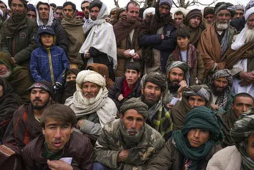Hundreds of Afghan men gather to apply for the humanitarian aid in Qala-e-Naw, Afghanistan, Tuesday, Dec. 14, 2021. In a statement Tuesday, Jan. 11, 2022, the White House announced $308 million in additional humanitarian assistance for Afghanistan, offering new aid to the country as it edges toward a humanitarian crisis since the Taliban takeover nearly five months earlier. (AP Photo/Mstyslav Chernov, File)