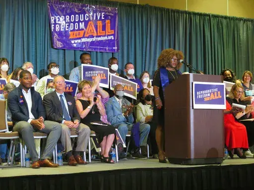 Elder Leslie Mathews, an organizer with Michigan United joins Leaders of the Reproductive Freedom for All campaign as they speak to supporters on Monday, July 11, 2022, in Lansing Mich., after turning in 753,759 signatures to qualify for Michigan's November ballot. (AP Photo/Joey Cappelletti)