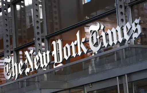 FILE - A sign for The New York Times hangs above the entrance to its building May 6, 2021, in New York. A New York judge has upheld an order preventing the Times from publishing documents between conservative group Project Veritas and its lawyer and ruled that the newspaper must immediately relinquish confidential legal memos it obtained. The decision Thursday, Dec. 23, by State Supreme Court Justice Charles D. Wood in Westchester County, released Friday, comes in a defamation lawsuit Project Ve