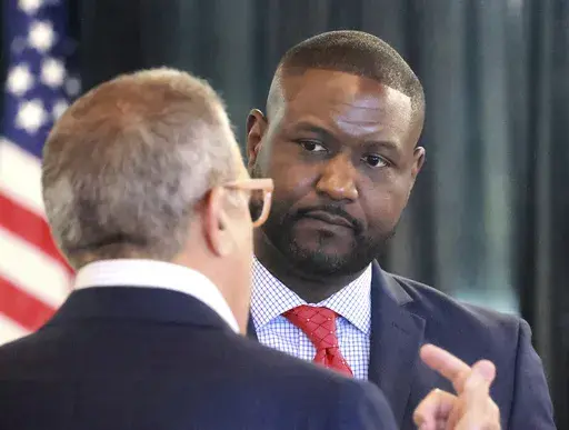 Central Florida Tourism Oversight District board administrator Glen Gilzean listens to chairman Martin Garcia, left, during the board's meeting in the headquarters of the former Reedy Creek Improvement District at Walt Disney World in Lake Buena Vista, Fla., Aug. 23, 2023. Less than a year after being picked to lead Walt Disney World's government after it was taken over by Gov. Ron DeSantis' allies, the district's administrator was appointed by the Florida governor on Monday, March 4, 2024 to ru