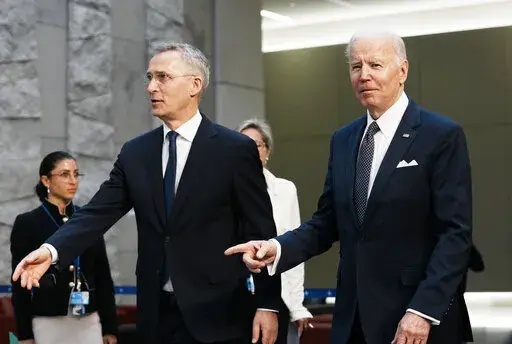 U.S. President Joe Biden, right, walks with NATO Secretary General Jens Stoltenberg prior to a group photo during an extraordinary NATO summit at NATO headquarters in Brussels, Thursday, March 24, 2022. As the war in Ukraine grinds into a second month, President Joe Biden and Western allies are gathering to chart a path to ramp up pressure on Russian President Vladimir Putin while tending to the economic and security fallout that's spreading across Europe and the world. (AP Photo/Thibault Camus)