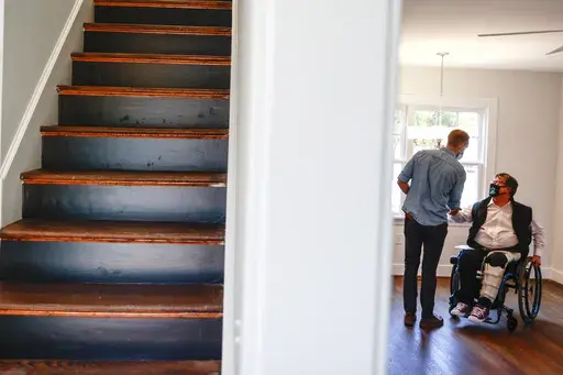 BoundaryLess Living founder and CEO William Sweeney, chats with an attendee on Nov. 17, 2021 at a BoundaryLess Living adaptive living home in Richmond, Va. Roughly 1.8 million businesses in the U.S. are owned by someone with a disability, according to the American Community Survey conducted by the U.S. Census Bureau. And while the path to entrepreneurship is rarely easy, business owners with disabilities often need to overcome additional challenges, like societal misconceptions, barriers to fina