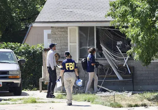Law enforcement investigate the scene of a shooting involving the FBI, Aug. 9, 2023 in Provo, Utah. This week's confrontation that ended with FBI agents fatally shooting a 74-year-old Utah man who threatened to assassinate President Joe Biden was just the latest example of how violent rhetoric has created a more perilous political environment across the U.S. (Laura Seitz/The Deseret News via AP, File)