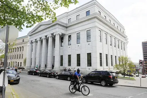 A cyclist rides past the New York Court of Appeals, May 5, 2015, in Albany, N.Y. New York’s highest court on Tuesday, Dec. 12, 2023, ordered the state to draw new congressional districts ahead of the 2024 elections, giving Democrats a potential advantage in what is expected to be a battleground for control of the U.S. House. (AP Photo/Hans Pennink, File)