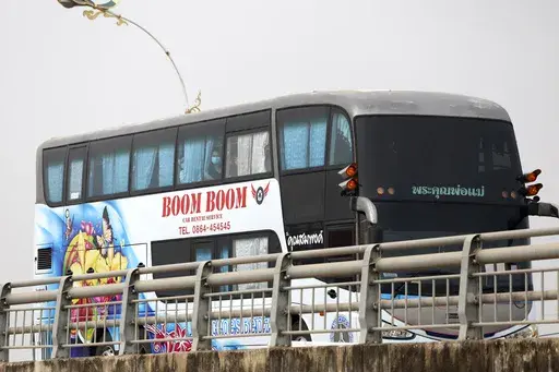 A bus, believed to be carrying Chinese nationals who have worked at scam centers in eastern Myanmar, crosses the 2nd Thai-Myanmar Friendship Bridge in Mae Sot in Thailand's Tak province before being flown back to China on Thursday, Feb. 20, 2025. (AP Photo/Sarot Meksophawannakul)