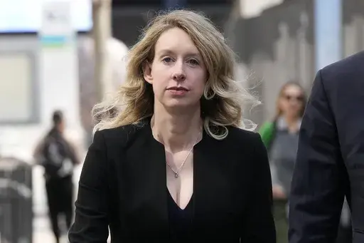 Former Theranos CEO Elizabeth Holmes leaves federal court in San Jose, Calif., March 17, 2023. Holmes has asked a federal judge, Wednesday, May 17, 2023, to allow her to remain free through the Memorial Day weekend before surrendering to authorities on May 30, to begin her more than 11-year prison sentence for defrauding investors in a blood-testing scam. (AP Photo/Jeff Chiu, File)