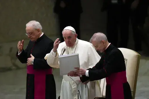 Pope Francis delivers his blessing at the end of his weekly general audience in the Paul VI Hall, at the Vatican, Wednesday, Dec. 22, 2021. (AP Photo/Alessandra Tarantino)