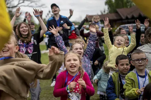 Children dance at the recovery camp for children and their mothers affected by the war near Lviv, Ukraine, Wednesday, May 3, 2023. A generation of Ukrainian children have seen their lives upended by Russia's invasion of their country. Hundreds of kids have been killed. For the survivors, the wide-ranging trauma is certain to leave psychological scars that will follow them into adolescence and adulthood. UNICEF says an estimated 1.5 million Ukrainian children are at risk of mental health issues. 