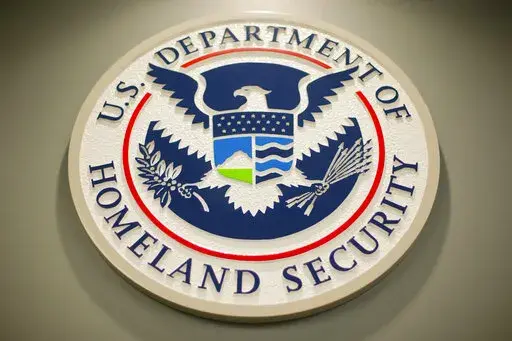 The Homeland Security logo is seen during a joint news conference in Washington, Feb. 25, 2015. The Homeland Security Department said Friday that Cameroonians would be temporarily shielded from deportation, saying extreme violence between government forces and armed separatists in the African nation made conditions unsafe for people to return. (AP Photo/Pablo Martinez Monsivais, File)