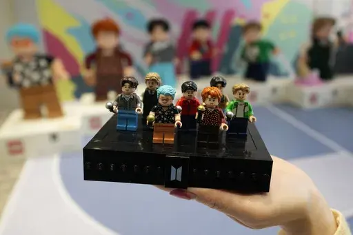 A LEGO set made of its blocks featuring K-pop band BTS, is shown during a publicity event at a store in Seoul, South Korea, on March 2, 2023. Danish toymaker Lego said Monday Sept. 25, 2023 that an experiment to make its colorful building bricks out of recycled drinks bottles didn’t work but the world’s largest toymaker “remains committed” to its plans to find sustainable materials to reduce carbon emission. (AP Photo/Lee Jin-man, File)