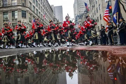 Bagpipers march up Fifth Avenue while they pass in front of St. Patrick Cathedral during the St. Patrick's Day Parade, Thursday, March 17, 2022, in New York.  St. Patrick’s Day celebrations across the country are back after a two-year hiatus. That includes New York City's parade, the nation's largest and oldest. It's a sign of growing hope that the worst of the coronavirus pandemic may be over. (AP Photo/Eduardo Munoz Alvarez)