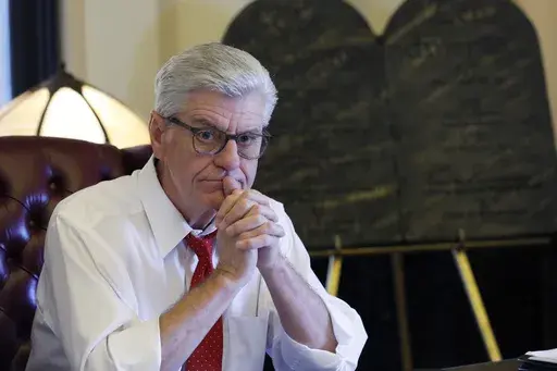 During his final week in office, Mississippi Republican Gov. Phil Bryant ponders a question in the state Capitol in Jackson, Miss., on, Jan. 8, 2020. Nancy New, who was convicted in 2022 in a welfare misspending case, said in a court filing Feb. 26, 2024, that Bryant told people in 2019, during his final weeks of office, that he had been offered a financial stake in a company that had received welfare money for its effort to develop a concussion drug. (AP Photo/Rogelio V. Solis, File)
