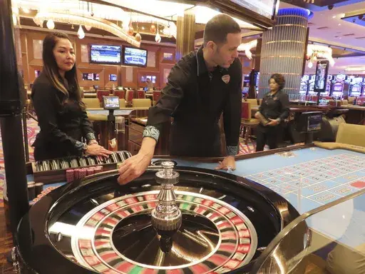 Dealers conduct a game of roulette at the Hard Rock casino in Atlantic City, N.J., on May 17, 2023. Commercial casinos in the U.S. had their best July ever this year, winning nearly $5.4 billion from gamblers, according to figures released on Sept. 14, 2023, by a national gambling industry group. (AP Photo/Wayne Parry)