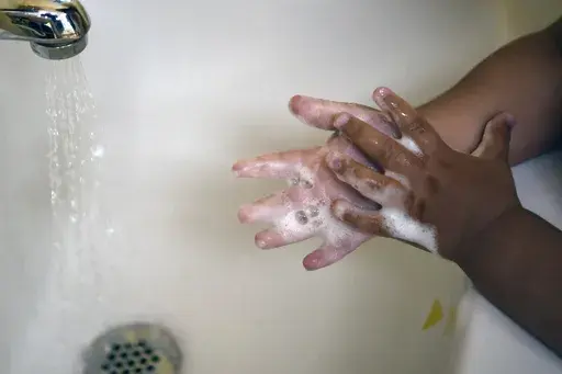 A child washes her hands at a day care center in Connecticut on Thursday Aug. 27, 2020. (AP Photo/Jessica Hill, File)