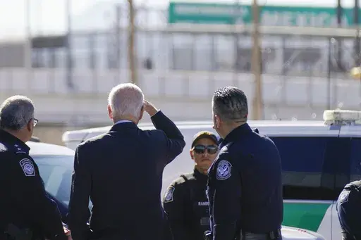 President Joe Biden, second from left, looks towards a large "Welcome to Mexico" sign that is hung over the Bridge of the Americas as he tours the El Paso port of entry, a busy port of entry along the U.S.-Mexico border, in El Paso Texas, Sunday, Jan. 8, 2023. (AP Photo/Andrew Harnik, File)
