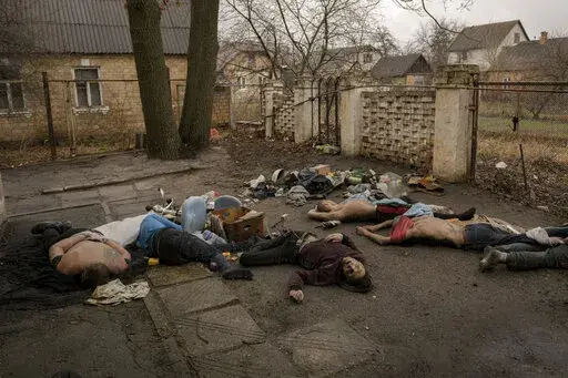 EDS NOTE: GRAPHIC CONTENT - Lifeless bodies of men, some with their hands tied behind their backs lie on the ground in Bucha, Ukraine, Sunday, April 3, 2022. Associated Press journalists in Bucha, a small city northwest of Kyiv, saw the bodies of at least nine people in civilian clothes who appeared to have been killed at close range. At least two had their hands tied behind their backs. (AP Photo/Vadim Ghirda)
