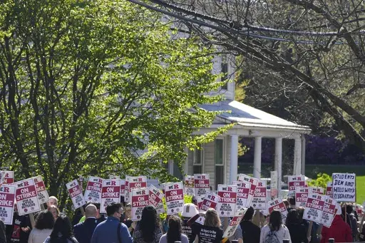 Strikers march in front of Rutgers' buildings in New Brunswick, N.J., Monday, April 10, 2023. Thousands of professors, part-time lecturers and graduate student workers at New Jersey's flagship university have gone on strike — the first such job action in the school's 257-year history. (AP Photo/Seth Wenig)