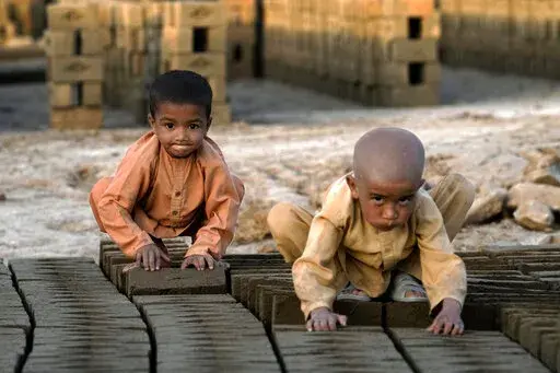 Afghan children work in a brick factory on the outskirts of Kabul, Afghanistan, Tuesday, July 26, 2022. Aid agencies say the number of children working in Afghanistan is growing ever since the economy collapsed following the Taliban takeover more than a year ago. (AP Photo/Ebrahim Noroozi)