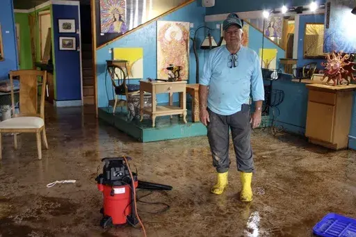 Freddie Pell stands in his art gallery in downtown Boone, N.C., that was flooded when Tropical Storm Helene passed over western North Carolina, Monday, Sept. 30, 2024. (AP Photo/Makiya Seminera)