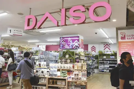 Shoppers visit a Daiso shop as the shop opened to the media in Tokyo, on April 13, 2022. Hirotake Yano, who founded the retail chain Daiso known for its 100-yen shops, Japan’s equivalent of the dollar store, has died. He was 80.(Kyodo News via AP)