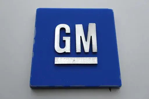 The General Motors logo is displayed outside the General Motors Detroit-Hamtramck Assembly plant, Jan. 27, 2020, in Hamtramck, Mich. General Motors is offering buyouts to most of its U.S. salaried workforce and some global executives in an effort to trim costs as it makes the transition to electric vehicles. (AP Photo/Paul Sancya, File)