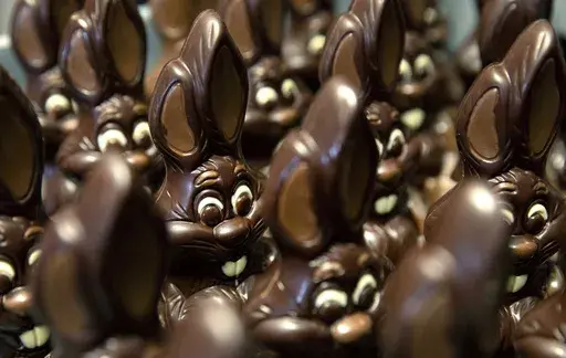 Chocolate rabbits wait to be decorated at the Cocoatree chocolate shop, April 8, 2020, in Lonzee, Belgium. Sweet Easter baskets will likely come at a bitter cost this year for consumers as the price of cocoa climbs to record highs. (AP Photo/Virginia Mayo, File)