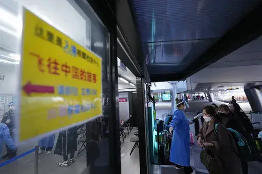 Passengers arriving from China enters a COVID-19 testing center at the Incheon International Airport in Incheon, South Korea, Tuesday, Jan. 10, 2023. China suspended visas Tuesday for South Koreans to come to the country for tourism or business in apparent retaliation for COVID-19 testing requirements on Chinese travelers. (AP Photo/Ahn Young-joon)