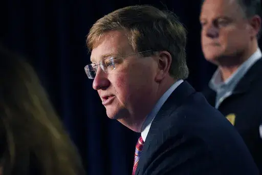 Mississippi Gov. Tate Reeves announces the state imposed boil-water notice has been lifted in Mississippi's capital city after nearly seven weeks, while Mississippi Emergency Management Agency executive director Stephen C. McCraney, right, listens, during a Sept. 15, 2022, news conference in Jackson. Repairs are still underway after problems at Jackson's main water treatment plant caused most customers to lose service for several days in late August and early September. Reeves blames Jackson's w