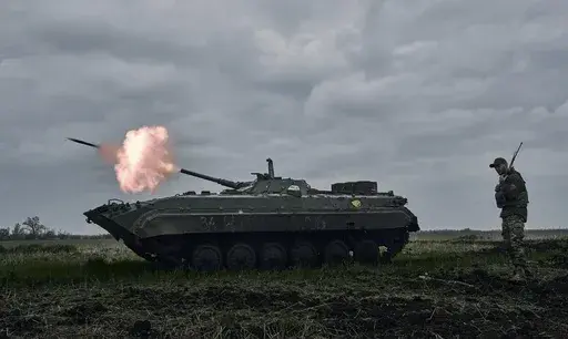 A Ukrainian APC fires towards Russian positions near Avdiivka, in the Donetsk region, Ukraine, Friday, April 28, 2023. A dayslong attempt by Russian forces to storm a strategically important city in eastern Ukraine appears to be running out of steam, Kyiv officials claimed Monday, Oct. 16, 2023 as the Kremlin’s war entered its 600th day. (AP Photo/Libkos, File)