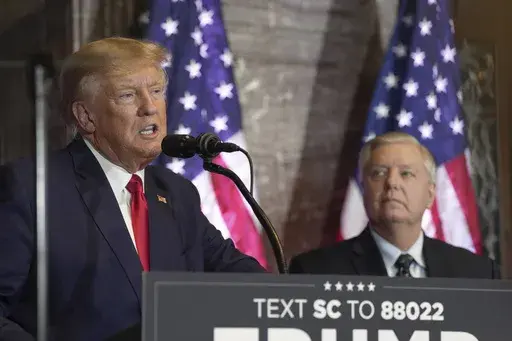 Former President Donald Trump, left, speaks at a campaign event as Sen. Lindsey Graham, R-S.C., looks on Jan. 28, 2023, in Columbia, S.C. The long and occasionally quixotic relationship between Trump and Graham has turned negative once more after the South Carolina senator criticized Trump's refusal to support a federal abortion ban. (AP Photo/Meg Kinnard, File)