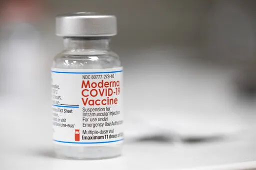 A vial of the Moderna COVID-19 vaccine is displayed on a counter at a pharmacy in Portland, Ore., Monday, Dec. 27, 2021. U.S. regulators have granted full approval to Moderna’s COVID-19 vaccine after reviewing additional data on its safety and effectiveness. The decision Monday, Jan. 31, 2022 by the Food and Drug Administration comes after many tens of millions of Americans have already received the shot under its original emergency authorization. Full approval means FDA has completed the same