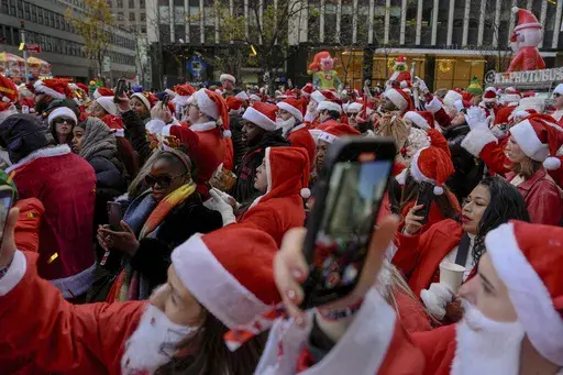 Revellers take part in SantaCon, Saturday, Dec. 14, 2024, in New York. (AP Photo/Julia Demaree Nikhinson)