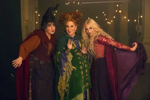 This image released by Disney shows, from left, Kathy Najimy as Mary Sanderson, Bette Midler as Winifred Sanderson, and Sarah Jessica Parker as Sarah Sanderson in "Hocus Pocus 2." (Matt Kennedy/Disney via AP)