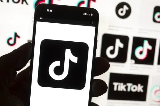 The TikTok logo is seen on a cell phone on Oct. 14, 2022, in Boston. TikTok will be banned from all Mississippi-issued government devices and the state’s network, Gov. Tate Reeves announced Wednesday, Jan. 11, 2023, in a letter to department and agency heads. Reeves says he issued the directive to safeguard sensitive information from the popular social media app. (AP Photo/Michael Dwyer, File)