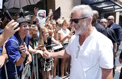 Mel Gibson, right, interacts with crowd members as he leaves a Hollywood Walk of Fame star ceremony for actor Vince Vaughn, on Aug. 12, 2024, in Los Angeles. (AP Photo/Chris Pizzello, File)