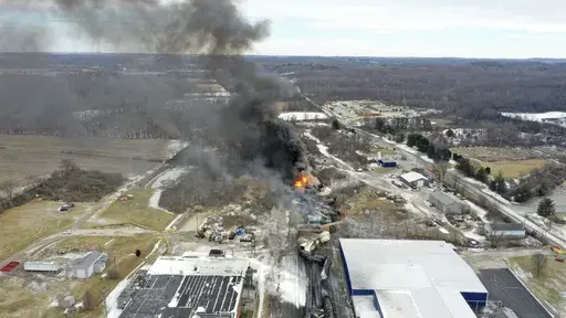 This photo taken with a drone shows portions of a Norfolk and Southern freight train that derailed Friday night in East Palestine, Ohio are still on fire at mid-day Saturday, Feb. 4, 2023. The federal government filed a lawsuit Thursday, March 30, against railroad Norfolk Southern over environmental damage caused by a February derailment on the Ohio-Pennsylvania border that spilled hazardous chemicals into nearby creeks and rivers. (AP Photo/Gene J. Puskar, File)