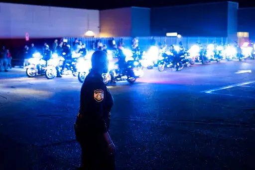 Officers and community members gathered at the beginning of a "Sea of Blue" in honor of fallen officer Geoffrey Redd that directly followed a visitation at Greater Community Temple on Monday, Feb. 27, 2023 in Memphis, Tenn. Redd was shot while responding to a confrontation at a library was remembered at his funeral Tuesday as a strong, proud and dedicated U.S. Marine and public servant. (Brad Vest/Daily Memphian via AP)