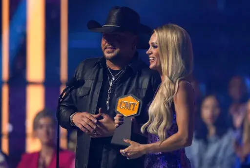 Jason Aldean, left, and Carrie Underwood accept the award for video of the year for "If I Didn't Love You" at the CMT Music Awards on Monday, April 11, 2022, at the Municipal Auditorium in Nashville, Tenn. (AP Photo/Mark Humphrey)