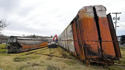 Some of the railcars that derailed Friday night when a Norfolk Southern freight train derailed are in the process of being cleaned up on Thursday, Feb. 9, 2023 in East Palestine, Ohio.(AP Photo/Gene J. Puskar)