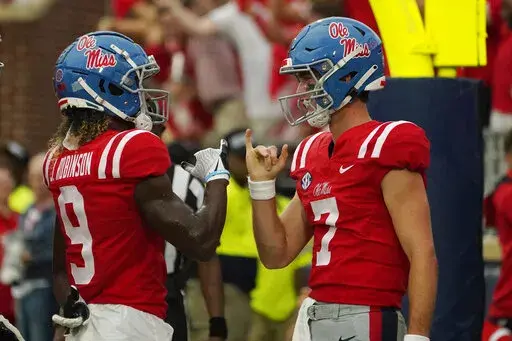 Mississippi quarterback Luke Altmyer (7) celebrates his one-yard rushing touchdown with Mississippi wide receiver Jaylon Robinson (9) during the first half of an NCAA college football game in Oxford, Miss., Saturday, Sept. 10, 2022. (AP Photo/Rogelio V. Solis)