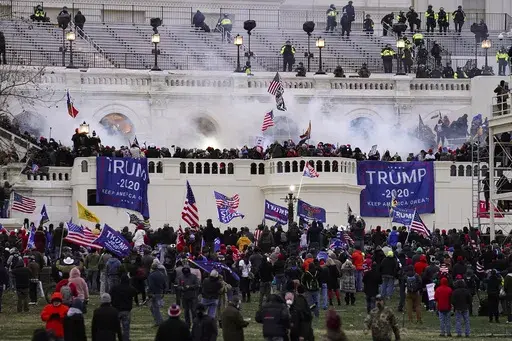 People loyal to President Donald Trump storm the U.S. Capitol on Jan. 6, 2021, in Washington. Federal authorities say a Southern California man who assaulted police with pepper spray during the storming of the U.S. Capitol was sentenced to 4 1/2 years in prison. The U.S. Department of Justice said in a statement Friday, April 28, 2023, that Jeffrey Scott Brown of Santa Ana, Calif., received a sentence of 54 months. (AP Photo/John Minchillo, File)